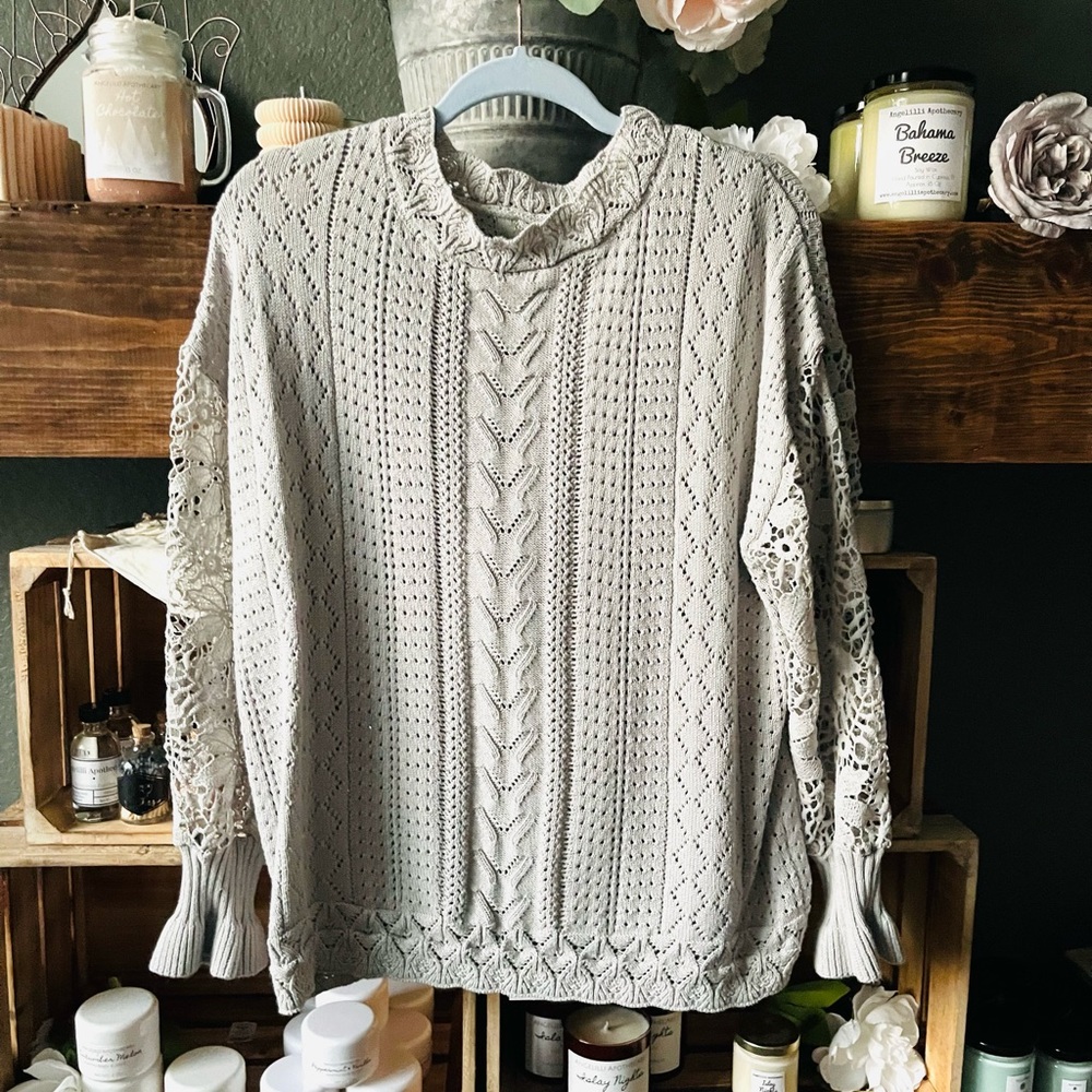 Sweater with open knit sleeves. Lighter weight.